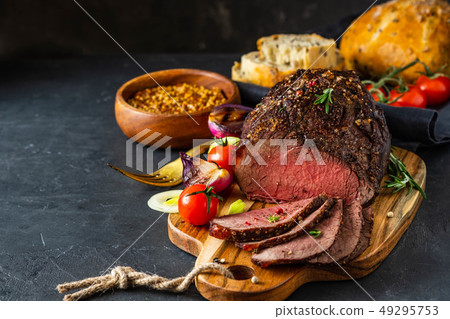 Fresh grilled meat. Grilled beef steak medium rare on wooden cutting board. Fresh grilled meat. Grilled beef steak medium rare on wooden cutting board. 49295753