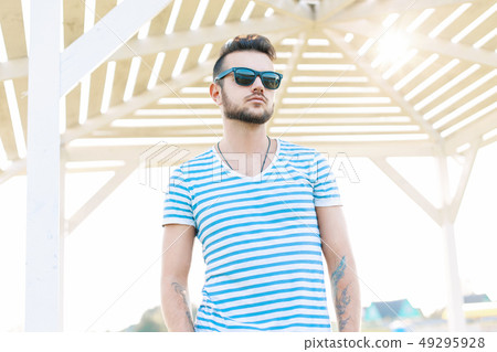 Handsome man with a beard in sunglasses resting  49295928