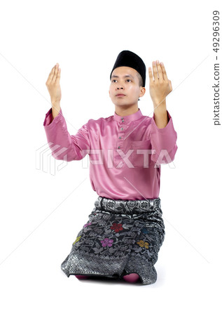 man with traditional clothing rising hand for pray 49296309