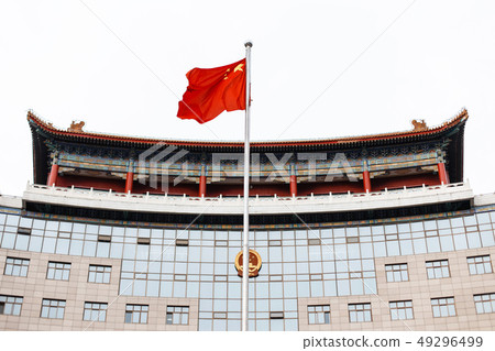 Chinese flag on a background of a modern building. Chinese flag on a background of a modern building. 49296499