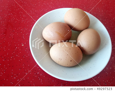 Four boiled eggs are placed on white plates. Four boiled eggs are placed on white plates. 49297323