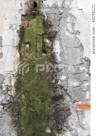 Texture of the old stone wall covered with moss Texture of the old stone wall covered with moss 49298172