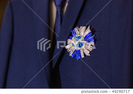 Groom's elegant flower boutonniere, located on the 49298717
