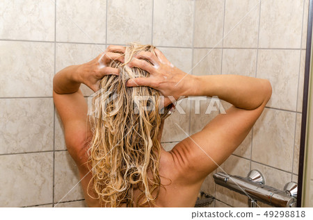 Woman washing her hair 49298818