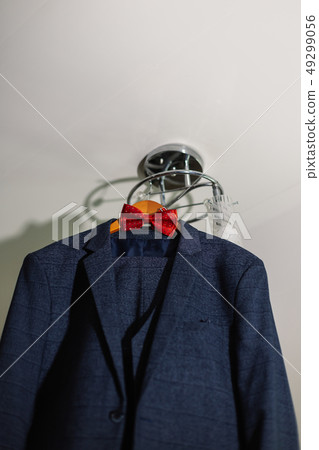 stylish black suit with white shirt and bow tie on 49299056