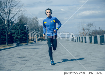 Man running on city background at morning. 49299692