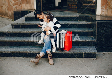 Mother with daughter in a city Mother with daughter in a city 49299720