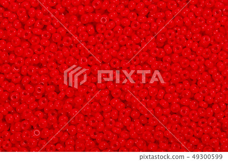 Many red glass beads. Photo beads for background. 49300599
