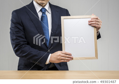 Men holding a board Men holding a board 49301487