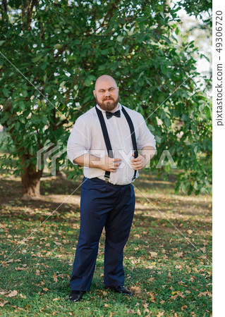 Stylish bearded fat groom in the park. Stylish bearded fat groom in the park. 49306720