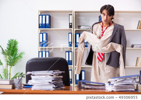 Crazy young man in straitjacket at the office  49306955