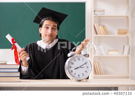 Graduate student in front of green board  49307110