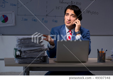 Young elegant financial specialist working in the office night t 49307348