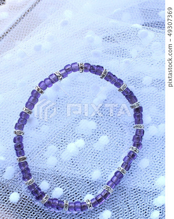 A sleek bracelet with purple beads and silver londel A sleek bracelet with purple beads and silver londel 49307369