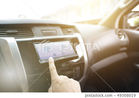 Driver searching for route using navigation system 49308019