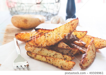 Baked potatoes served on paper Vegan food 49309961