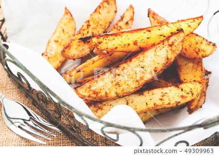 Baked potato wedges on basket - homemade organic 49309963