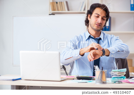 Young handsome businessman in budget planning concept Young handsome businessman in budget planning concept 49310407