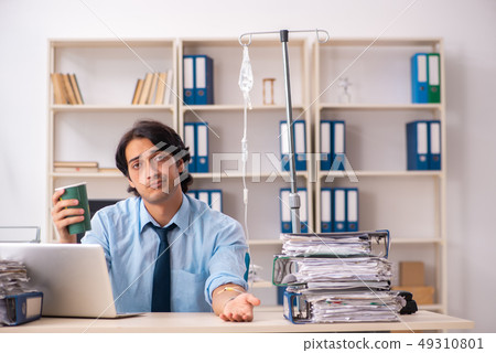 Young male employee in blood transfusion concept Young male employee in blood transfusion concept 49310801