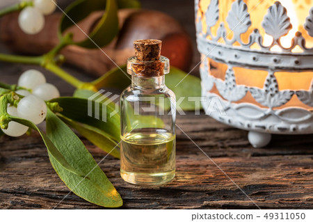 A bottle of essential oil with fresh mistletoe A bottle of essential oil with fresh mistletoe 49311050