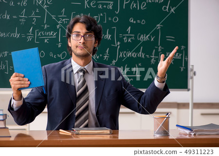 Young male math teacher in classroom Young male math teacher in classroom 49311223