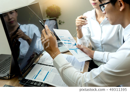 business man and woman sit at ther table 49311395