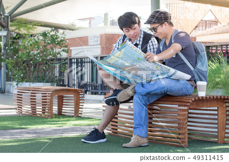 Two men are planning a trip to see the tourist map Two men are planning a trip to see the tourist map 49311415
