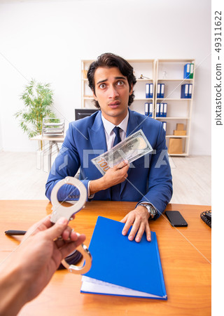 Young handsome judge sitting in courtroom Young handsome judge sitting in courtroom 49311622