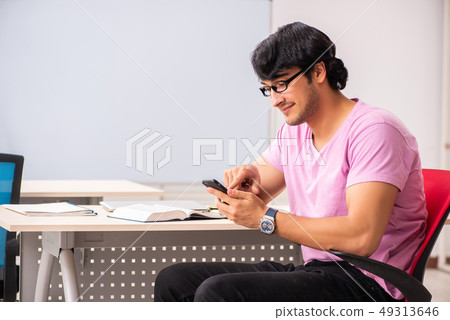 Young male student sitting in the class Young male student sitting in the class 49313646