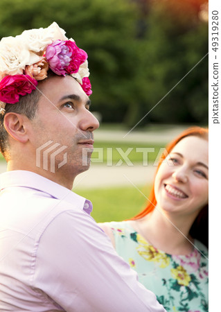 Man and woman fooling around on their date in park Man and woman fooling around on their date in park 49319280