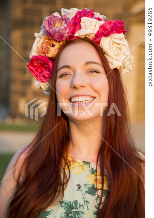 Portrait of woman with floral wreath on her head Portrait of woman with floral wreath on her head 49319285