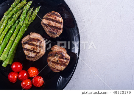 Grilled filet mignon with asparagus and tomatoes 49320179