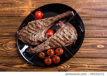 Grilled beef tomahawk steak Grilled beef tomahawk steak 49320232