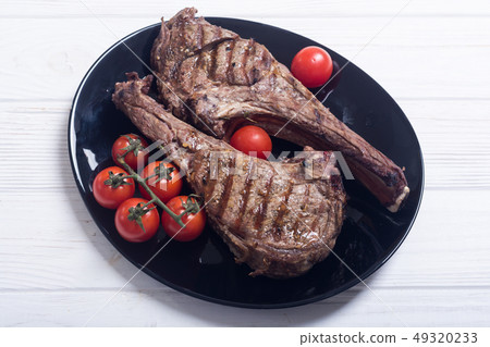 Grilled beef tomahawk steak Grilled beef tomahawk steak 49320233