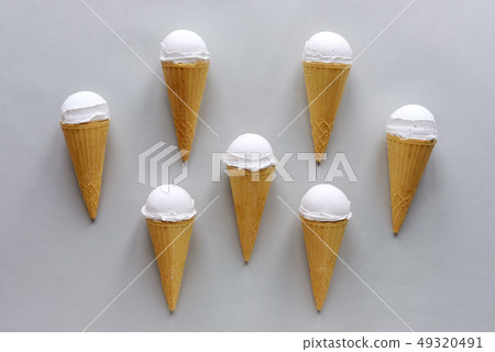Seven cornets with vanilla ice cream on grey 49320491