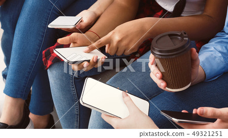Girl pointing finger on phone screen, showing new app 49321251