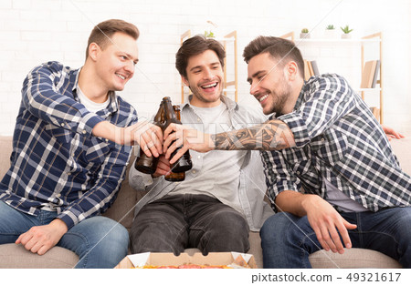 Cheers. Happy friends drinking beer at home 49321617