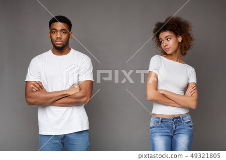 Offended black man and woman standing separately Offended black man and woman standing separately 49321805