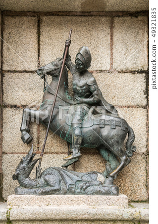 Detail of the sculpture of St. George killing the dragon in the Plaza de San Jorge in the old town 49321835