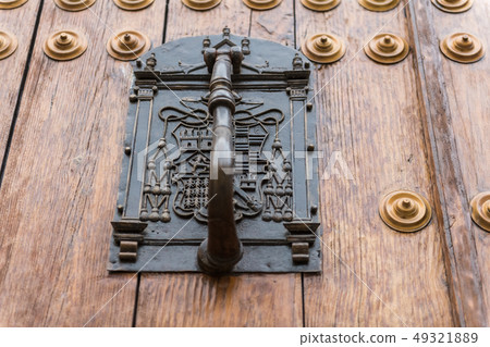 Detail of the knocker on the door of the bishopric in the old town of Caceres. Detail of the knocker on the door of the bishopric in the old town of Caceres. 49321889