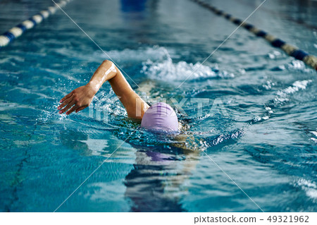 Female athlete swimming fast in crawl style.  49321962