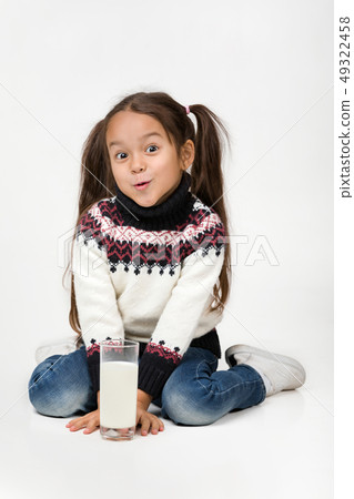 little child girl holding glass of milk on white background 49322458