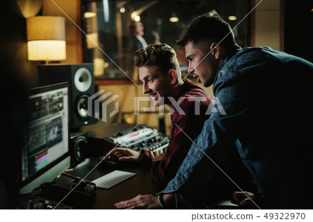 Sound engineer working in a music studio 49322970