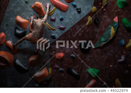 Athletic man practicing in a bouldering gym 49322974