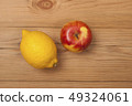 Lemon and apple on a wooden background. 49324061