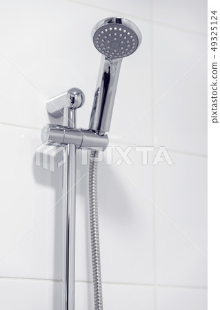 Shower chrome head in bathroom, white candid interior Shower chrome head in bathroom, white candid interior 49325124
