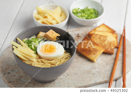 Egg noodle soup with bamboo shoots, tofu, and nori Egg noodle soup with bamboo shoots, tofu, and nori 49325302