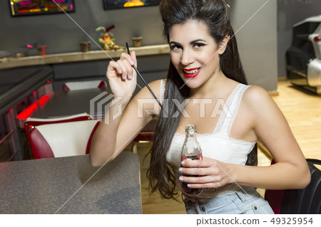 young pin up girl drinking 49325954