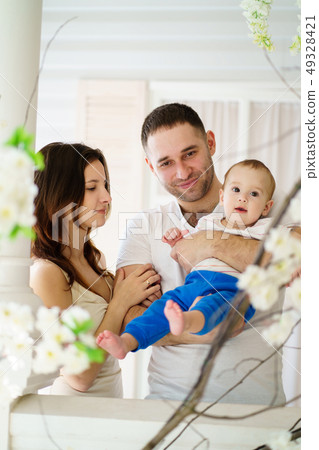 Mother and father hugging their baby son Mother and father hugging their baby son 49328421