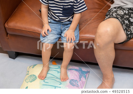 Grandson and grandpa sitting on the sofa Grandson and grandpa sitting on the sofa 49328515